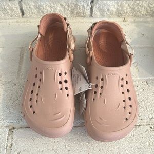 Light pink crocs, never worn with tags. Womens size 10, men size 8.